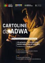 locandina informativa mostra con fotografia donna etiope che prega in una chiesa con candela accesa